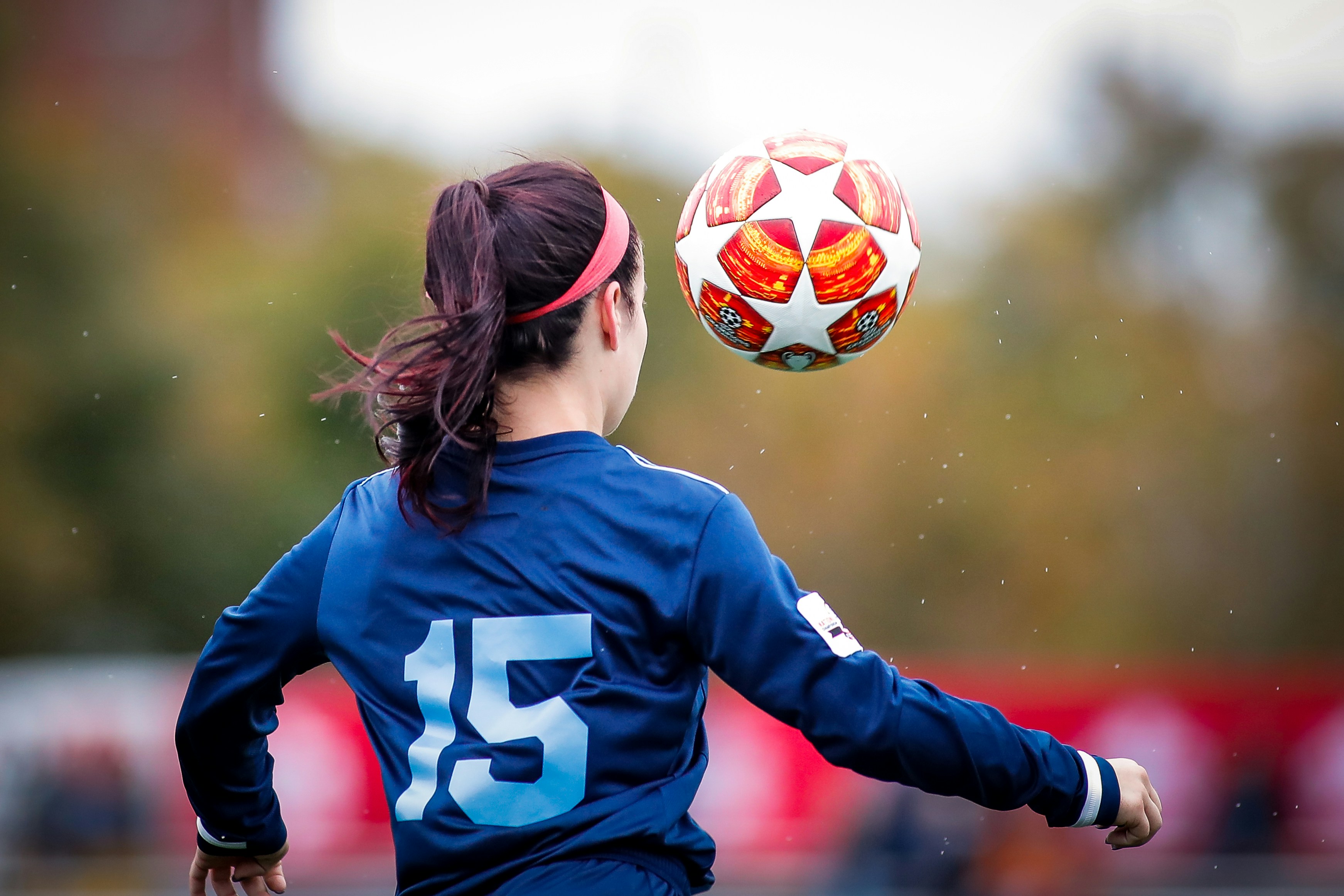 A young football player heading the ball during a training session