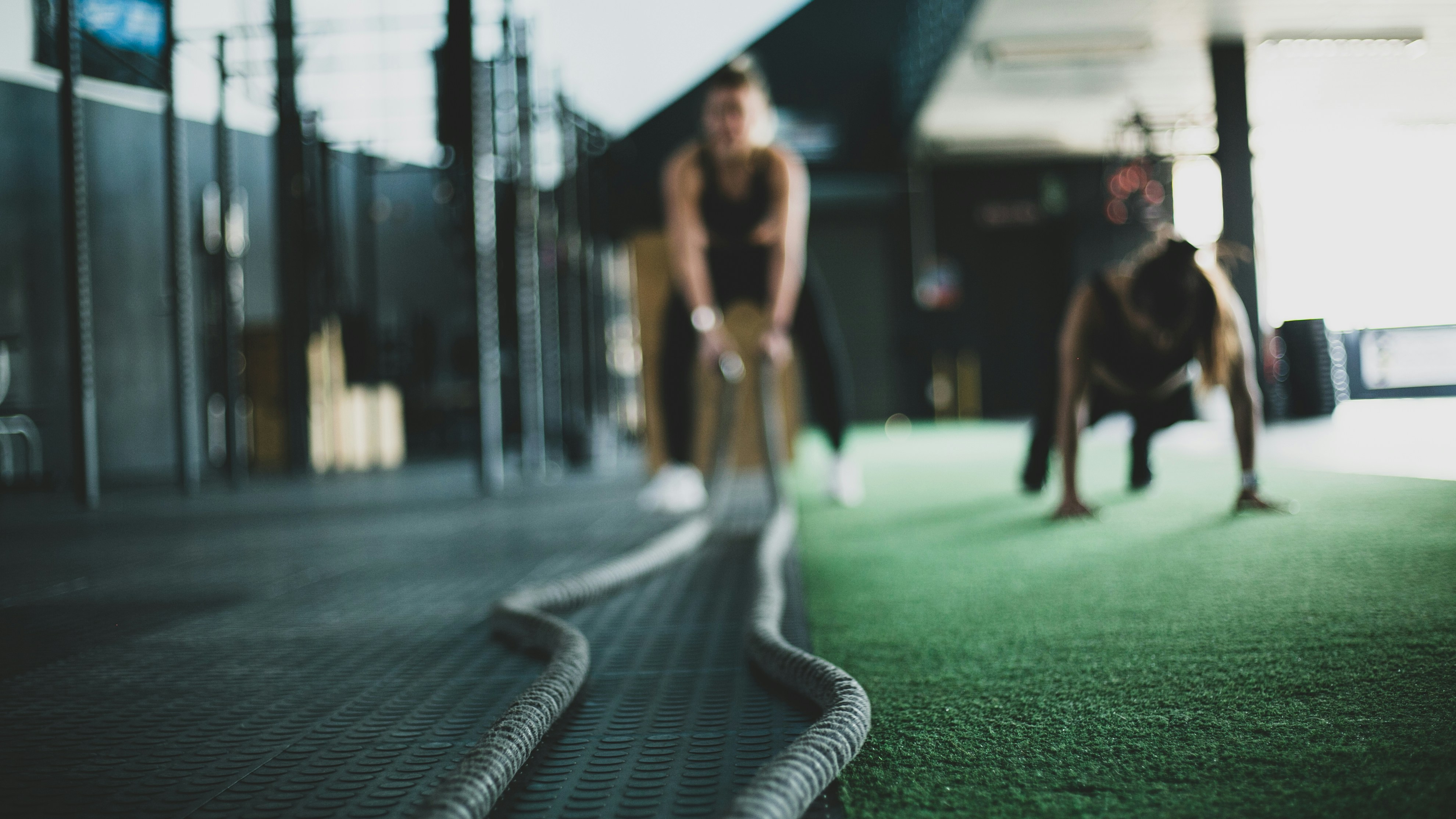 A young athlete's kit bag holding gear from several different sports — research tracing the childhoods of Olympic medallists and world champions finds this kind of multi-sport background, not early single-sport specialization, more often precedes elite adult performance.
