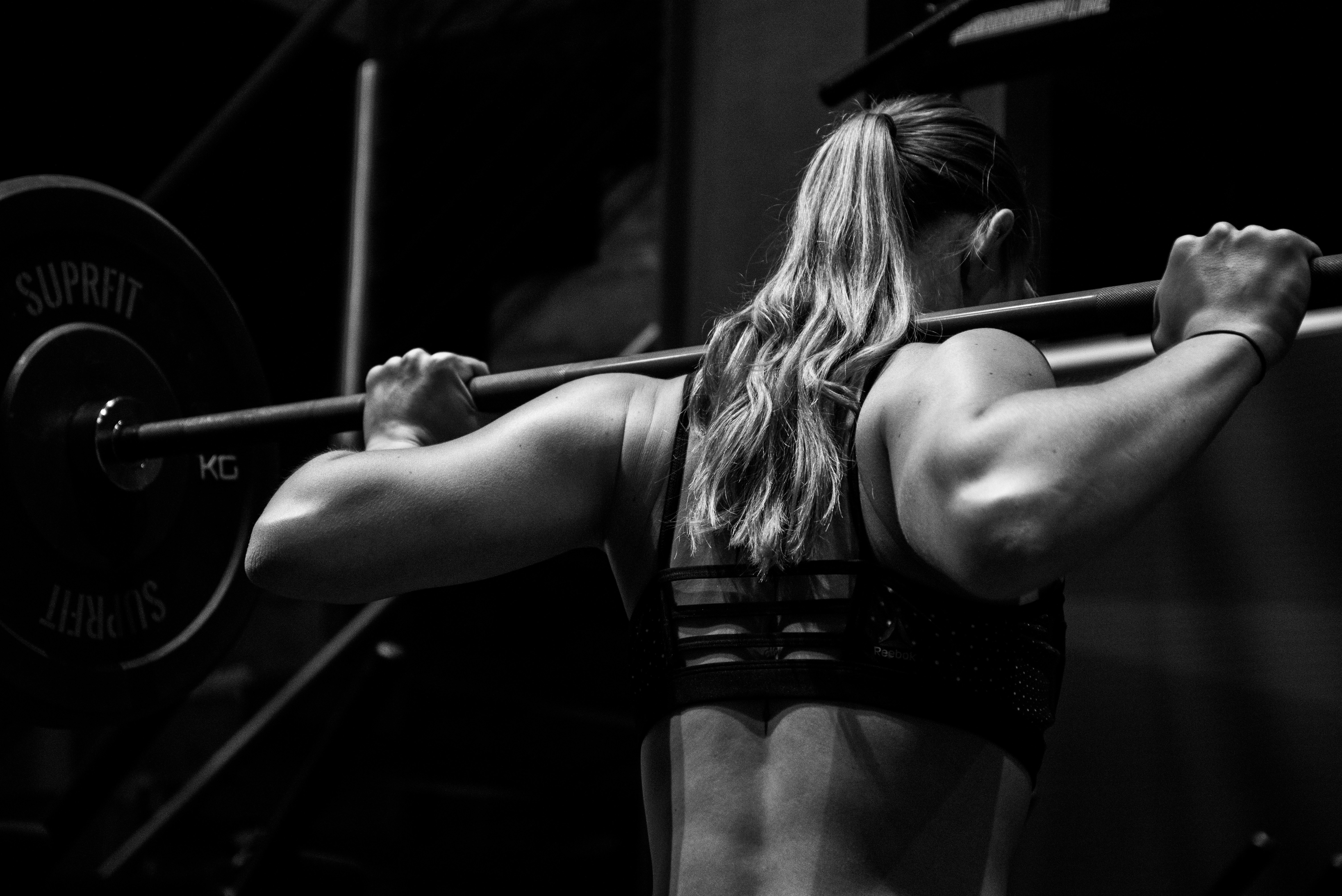An athlete performing a heavy back squat as a conditioning activity, the kind of exercise studied in post-activation potentiation research before a subsequent jump, sprint, or throw.