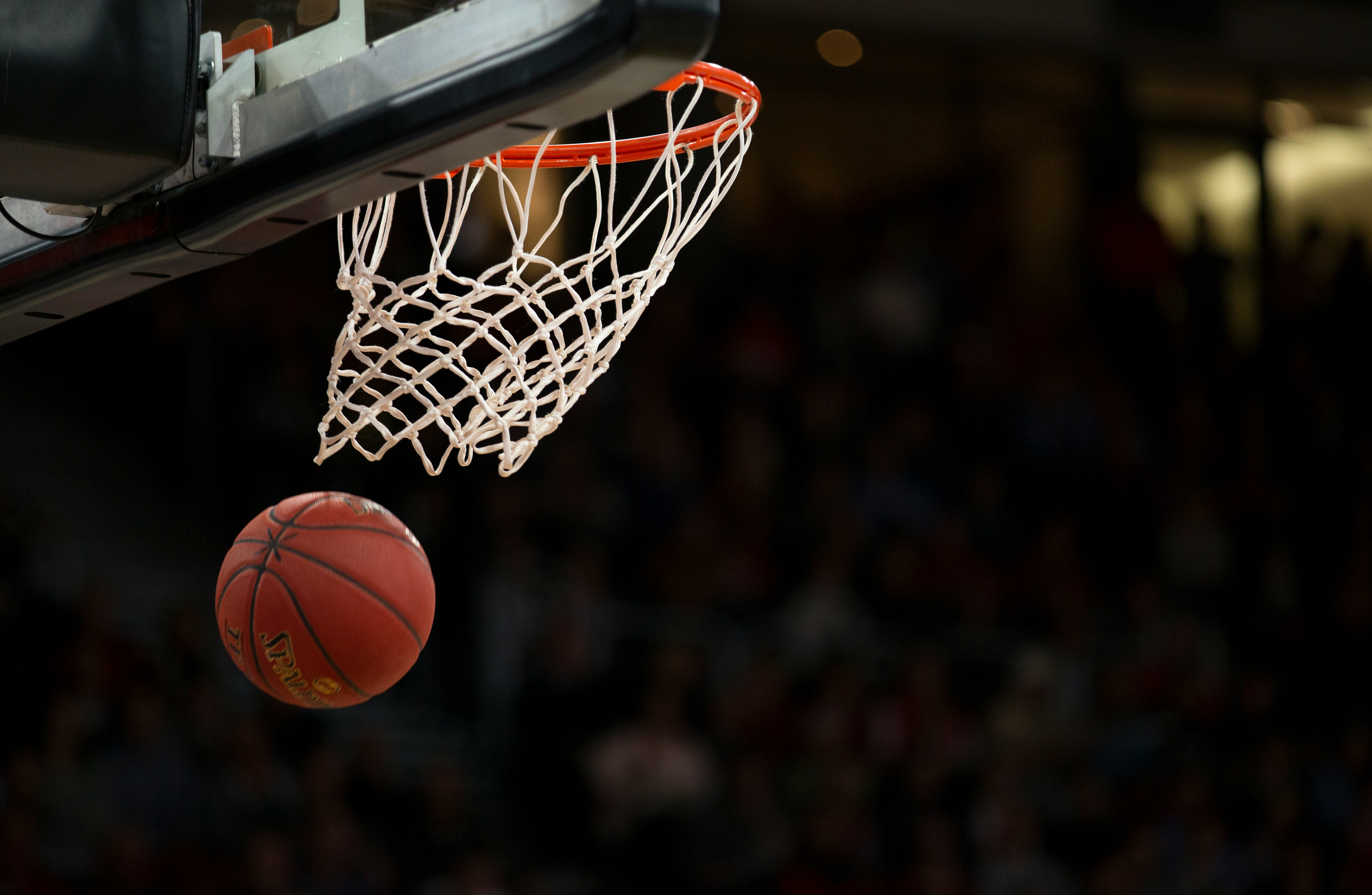 A young athlete standing still in focused preparation at the free-throw line before shooting.