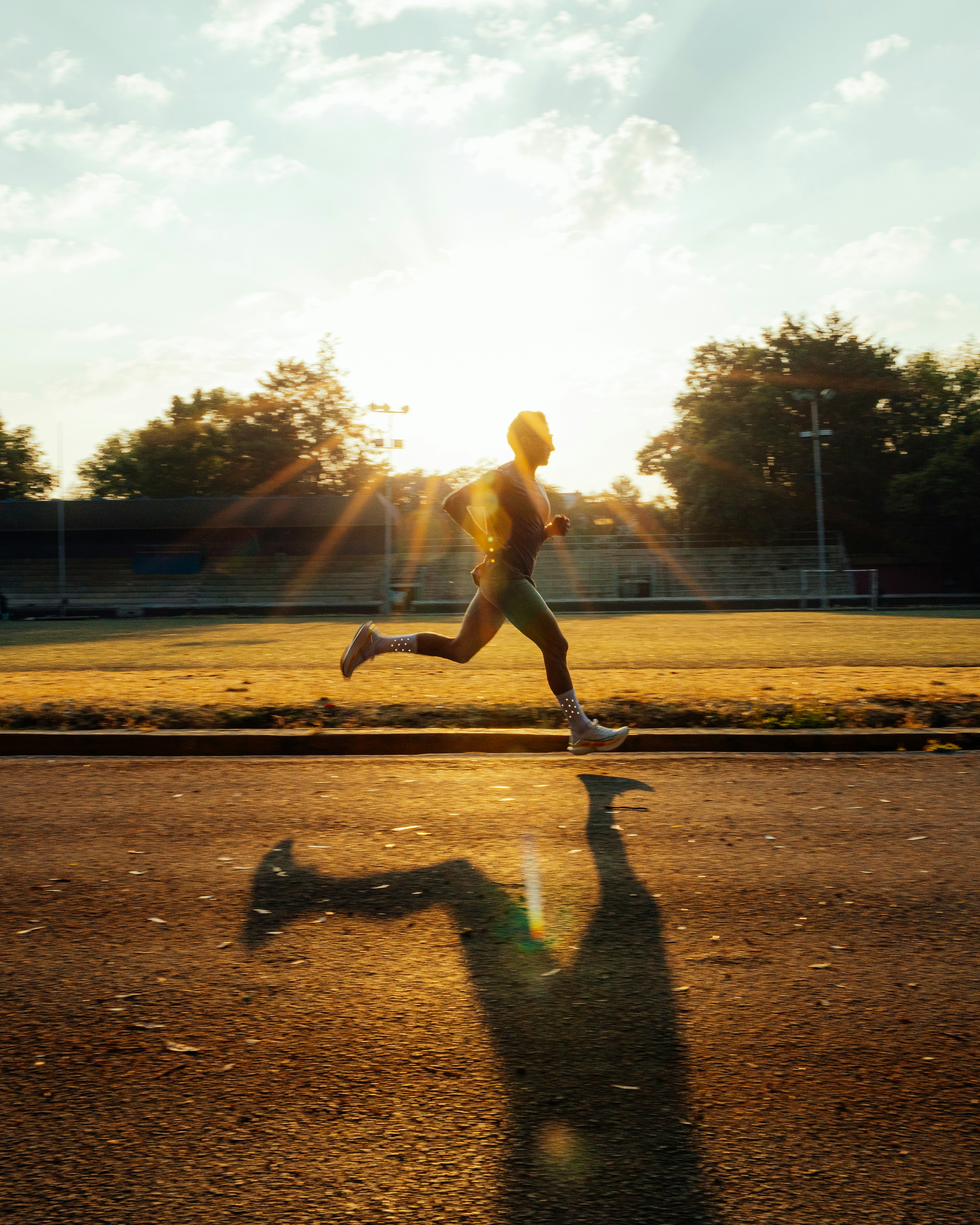 A sprinter in the drive phase of acceleration, torso low and front leg loaded into the track — the phase where ground-force research says technique actually separates fast athletes from slow ones.