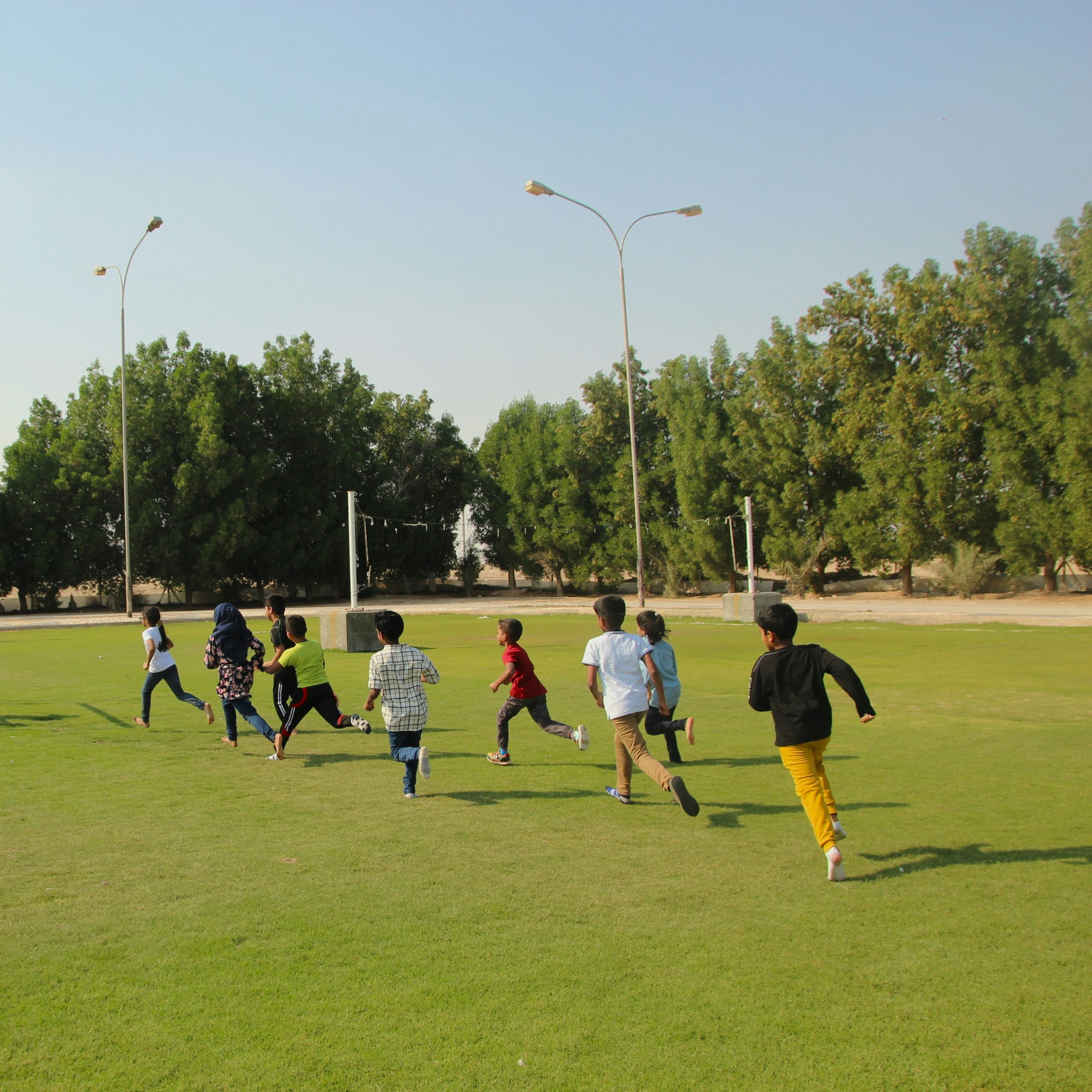 A young runner training on an outdoor track, illustrating research on safe running distances for children and adolescents